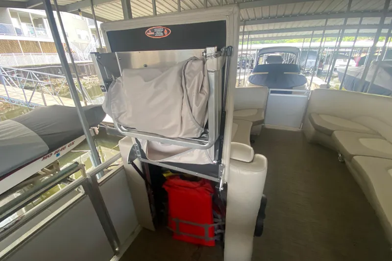Slide: The Image of 2018 Harris Solstice 240 pontoon boat interior with seating and storage compartments. - 24