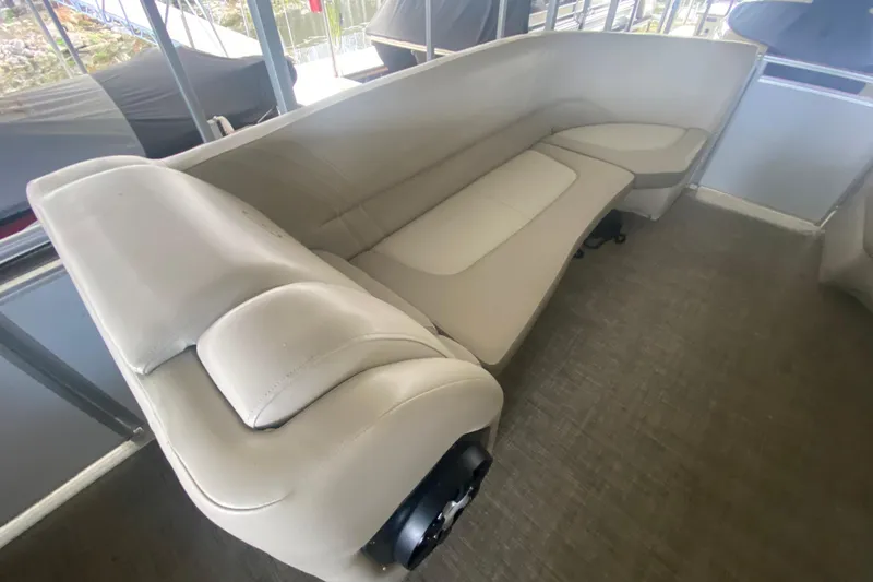 Slide: The Image of 2018 Harris Solstice 240 boat interior with beige seating and carpeted flooring. - 25