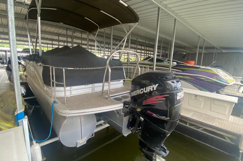 Slide: The Image of 2018 Harris Solstice 240 pontoon boat with Mercury 250 engine in covered dock. - 27