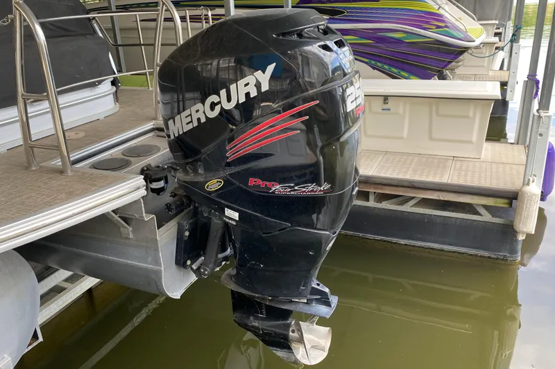 Slide: The Image of Mercury outboard motor on a 2018 Harris Solstice 240 pontoon boat at a dock. - 28