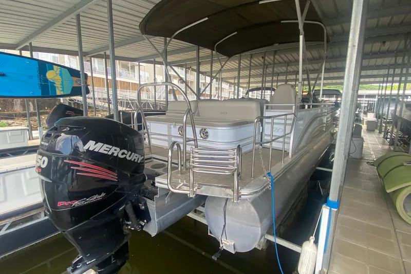 Slide: The Image of 2018 Harris Solstice 240 pontoon boat with Mercury 150 engine in covered dock. - 4