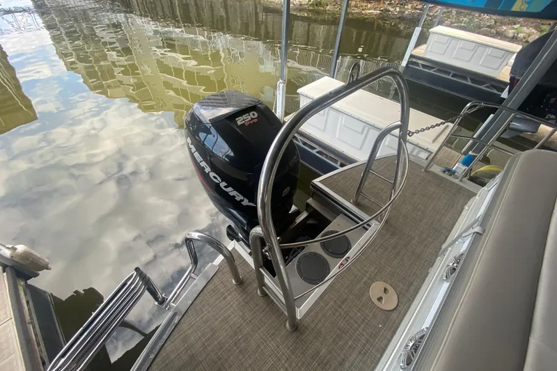 Slide: The Image of 2018 Harris Solstice 240 boat with Mercury 250 Pro outboard motor on a calm water dock. - 6