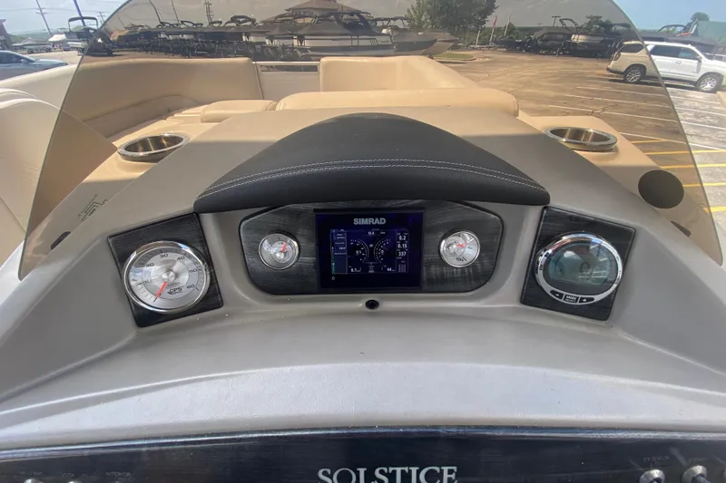 Slide: The Image of Dashboard of a 2018 Harris Solstice 240 boat with gauges and navigation display. - 18