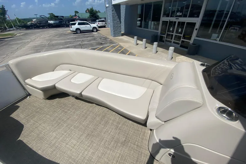Slide: The Image of 2018 Harris Solstice 240 boat interior with beige seating and carpeted flooring. - 10