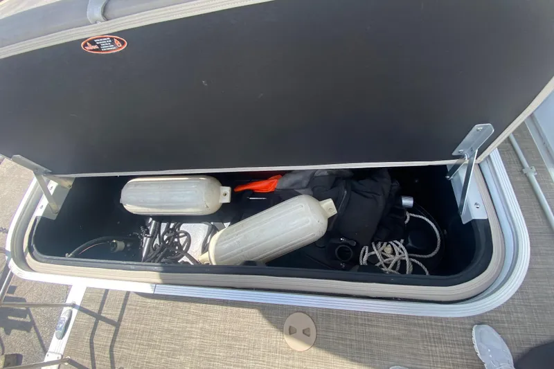 Slide: The Image of Storage compartment of 2018 Harris Solstice 240 boat with fenders and ropes. - 25
