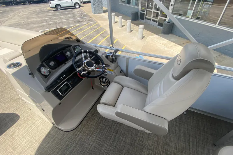 Slide: The Image of Captain's chair and helm of 2018 Harris Solstice 240 boat, featuring modern controls and dashboard. - 14