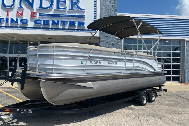 Slide: The Image of 2018 Harris Solstice 240 pontoon boat on trailer at dealership. - 1