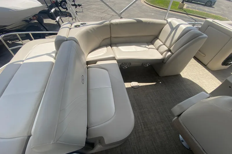 Slide: The Image of 2018 Harris Solstice 240 boat interior with beige seating and carpeted flooring. - 22