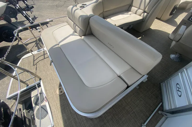 Slide: The Image of 2018 Harris Solstice 240 boat interior with beige seating and carpeted flooring. - 24