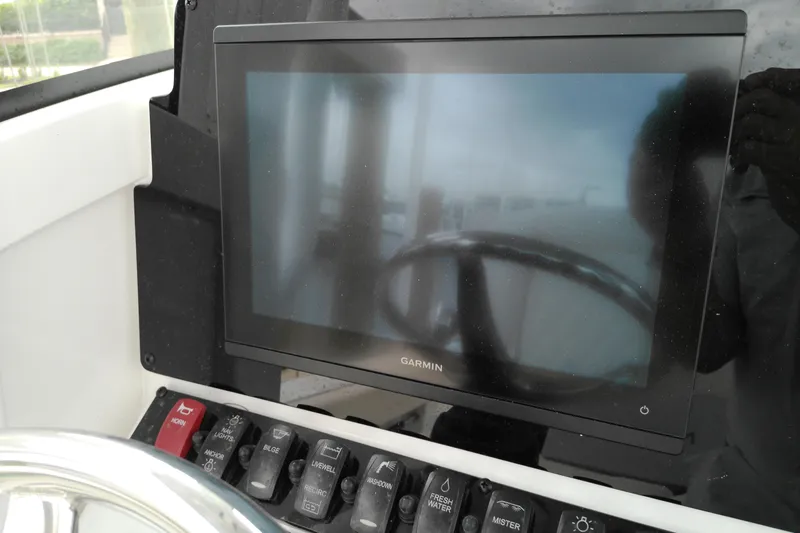 Slide: The Image of Garmin display and control panel on 2026 Sea Hunt Ultra 235 SE boat. - 12