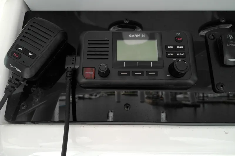 Slide: The Image of Garmin marine radio on 2026 Sea Hunt Ultra 235 SE boat dashboard. - 17