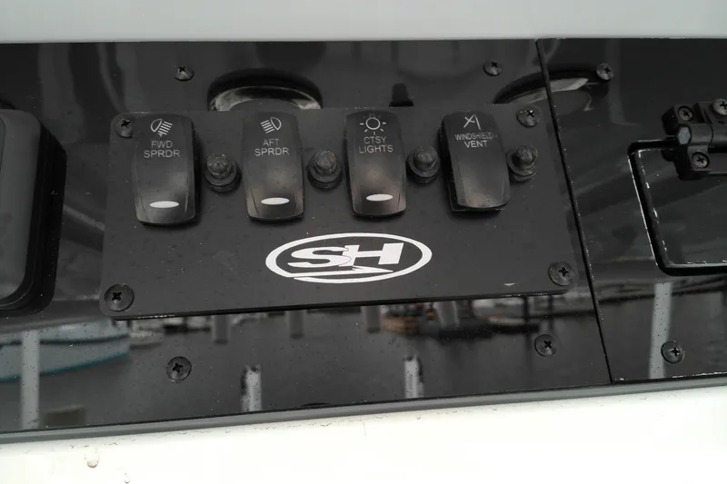 Slide: The Image of Control panel of 2026 Sea Hunt Ultra 235 SE boat with labeled switches. - 18