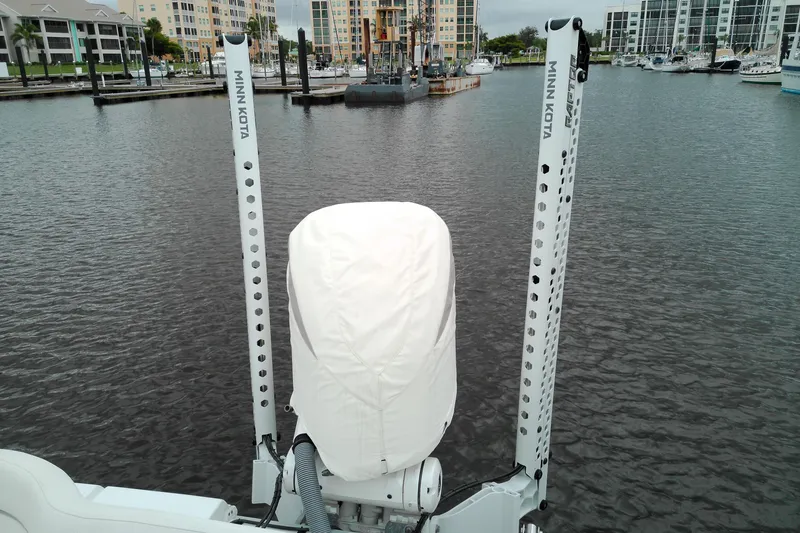 Slide: The Image of 2026 Sea Hunt Ultra 235 SE boat with Minn Kota trolling motor in marina. - 20