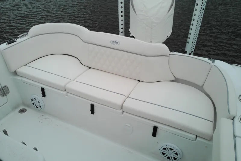 Slide: The Image of Luxurious seating on 2026 Sea Hunt Ultra 235 SE boat, featuring white cushioned upholstery. - 22