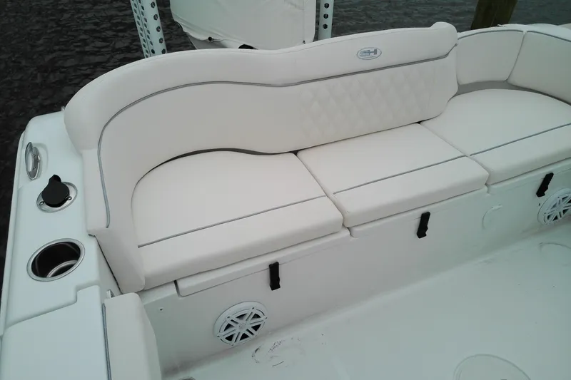 Slide: The Image of 2026 Sea Hunt Ultra 235 SE boat interior with white cushioned seating. - 24