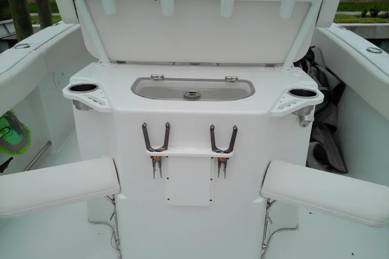 Slide: The Image of 2026 Sea Hunt Ultra 235 SE boat interior with fishing rod holders and seating. - 28