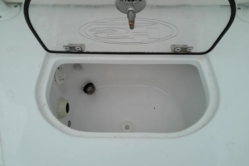 Slide: The Image of Livewell compartment of 2026 Sea Hunt Ultra 235 SE boat, open lid view. - 29