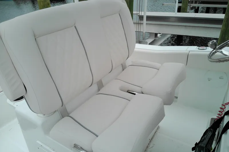Slide: The Image of 2026 Sea Hunt Ultra 235 SE boat with plush white seating. - 30