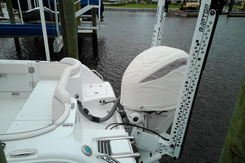 Slide: The Image of 2026 Sea Hunt Ultra 235 SE boat with covered outboard motor at dock. - 35
