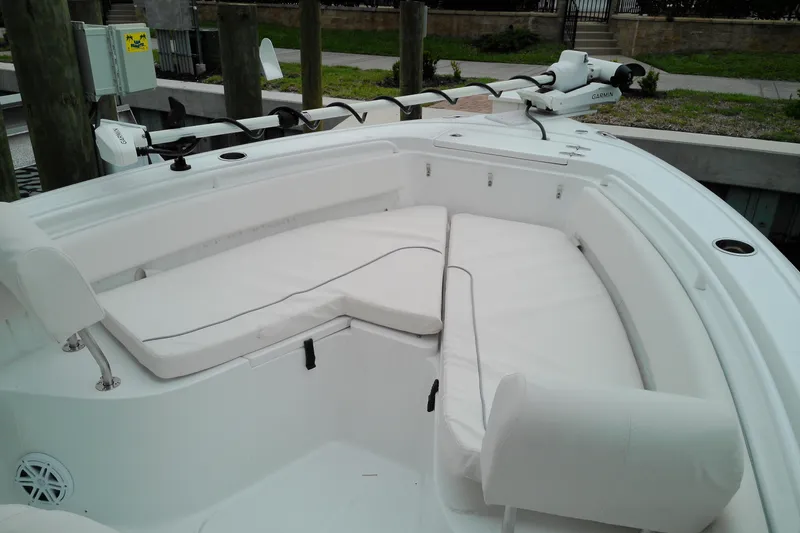 Slide: The Image of 2026 Sea Hunt Ultra 235 SE boat with spacious white seating area. - 4