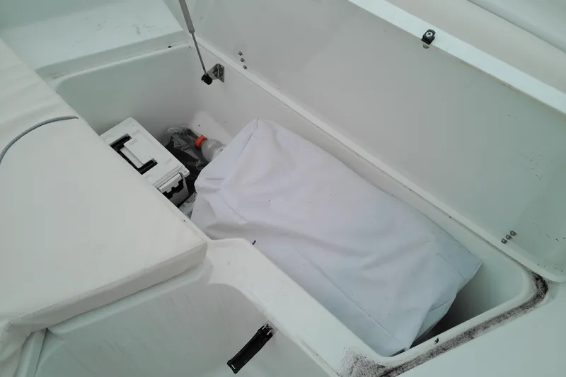 Slide: The Image of Storage compartment of 2026 Sea Hunt Ultra 235 SE boat with equipment and supplies. - 9