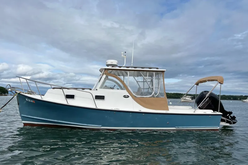 The Image of 2014 Seaway 24 Seafarer boat on calm water under cloudy sky. - 0