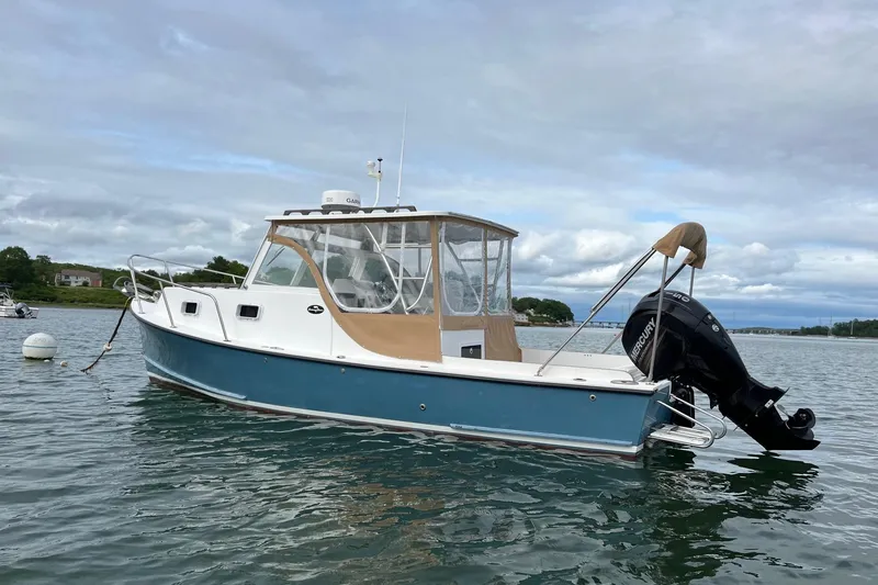 Slide: The Image of 2014 Seaway 24 Seafarer boat with outboard motor on calm water. - 1