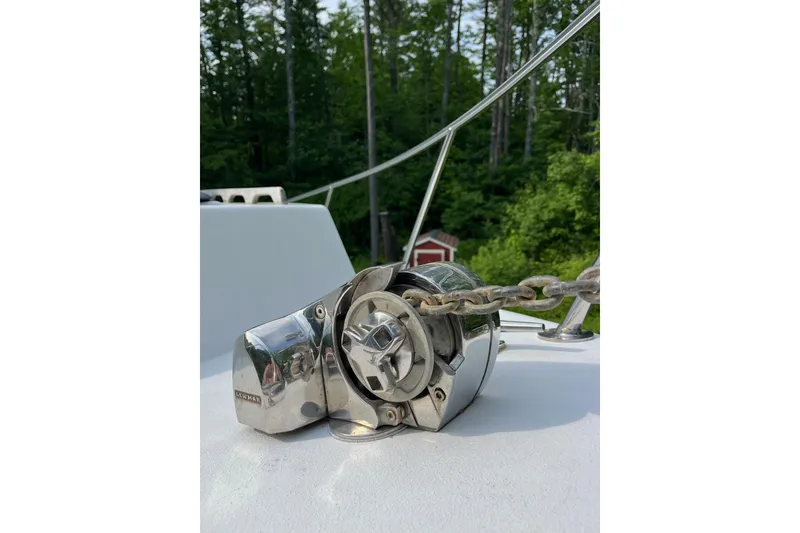 Slide: The Image of Chrome anchor windlass on 2014 Seaway 24 Seafarer boat deck, surrounded by trees. - 10