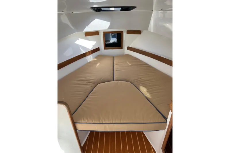 Slide: The Image of 2014 Seaway 24 Seafarer cabin interior with beige cushions and wooden accents. - 2