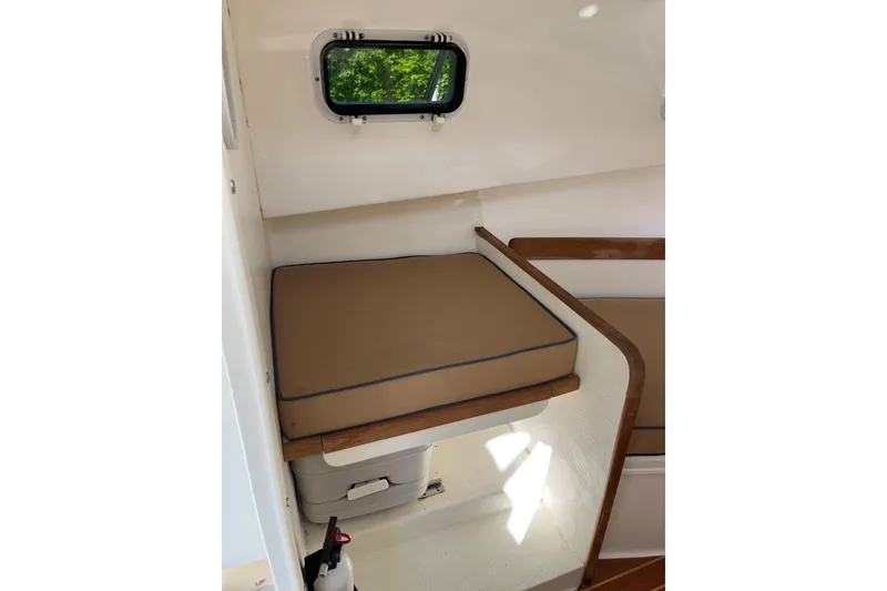 Slide: The Image of Interior cabin of 2014 Seaway 24 Seafarer boat with cushioned seating and window. - 5
