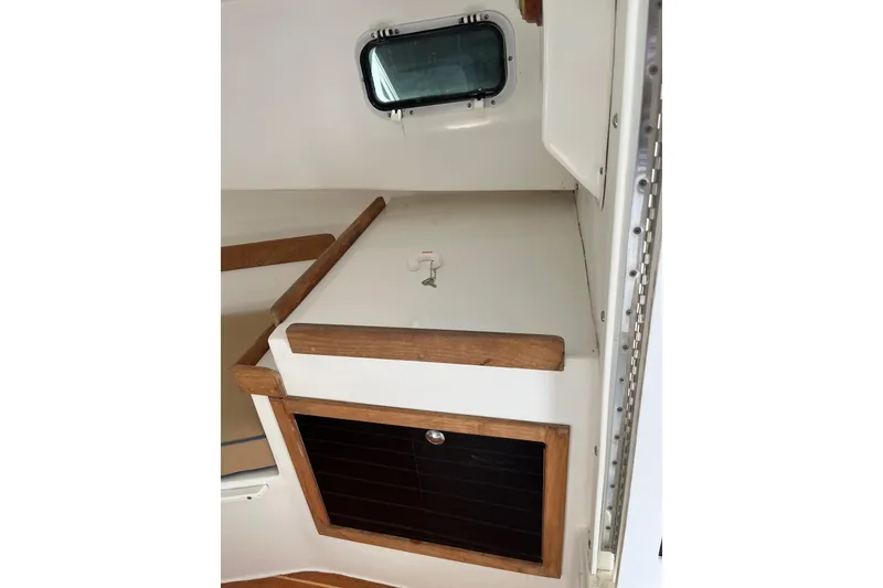 Slide: The Image of Interior cabin of 2014 Seaway 24 Seafarer boat with wooden accents and window. - 6