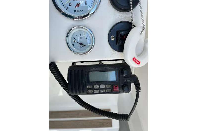 Slide: The Image of 2014 Seaway 24 Seafarer dashboard with gauges and marine radio. - 7