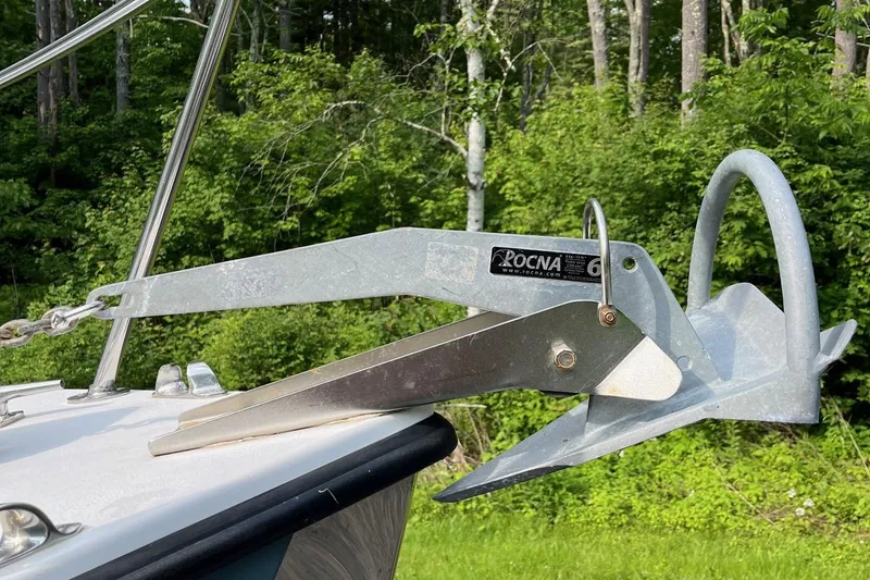 Slide: The Image of Anchor on 2014 Seaway 24 Seafarer boat, surrounded by lush green forest. - 9