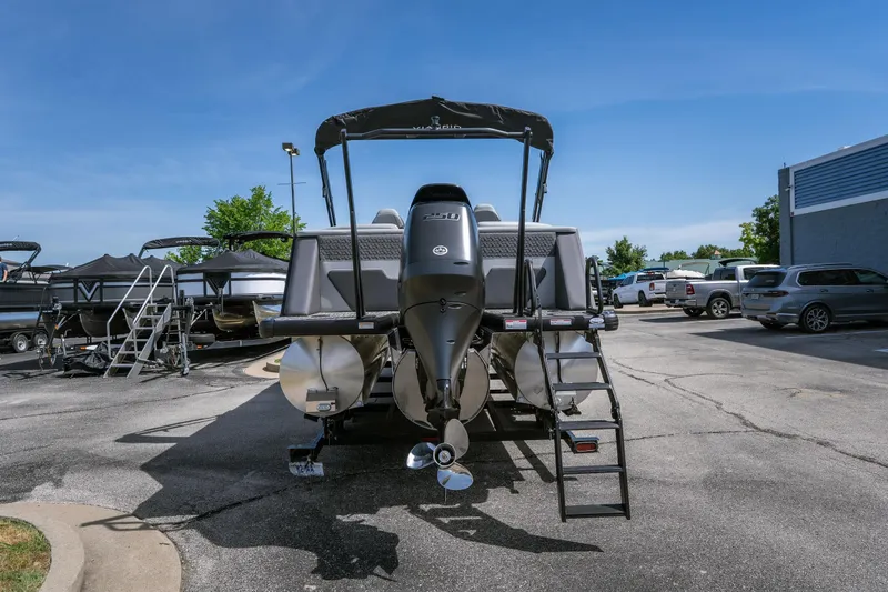 Slide: The Image of 2026 Viaggio Z24U pontoon boat with outboard motor in a dealership lot. - 21