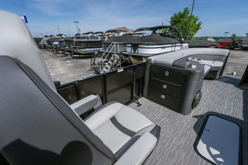 Slide: The Image of Interior of 2026 Viaggio Z24U pontoon boat with seating and storage, docked outdoors. - 10