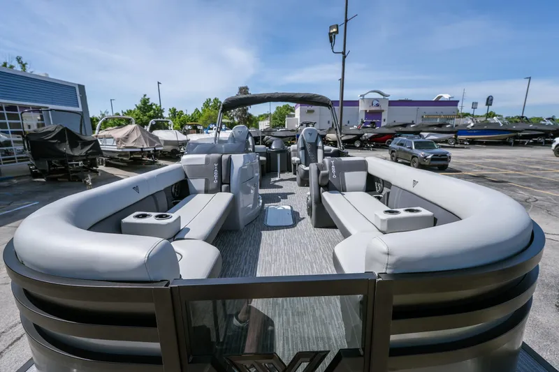 Slide: The Image of 2026 Viaggio Z24U pontoon boat with luxurious seating in a dealership lot. - 17
