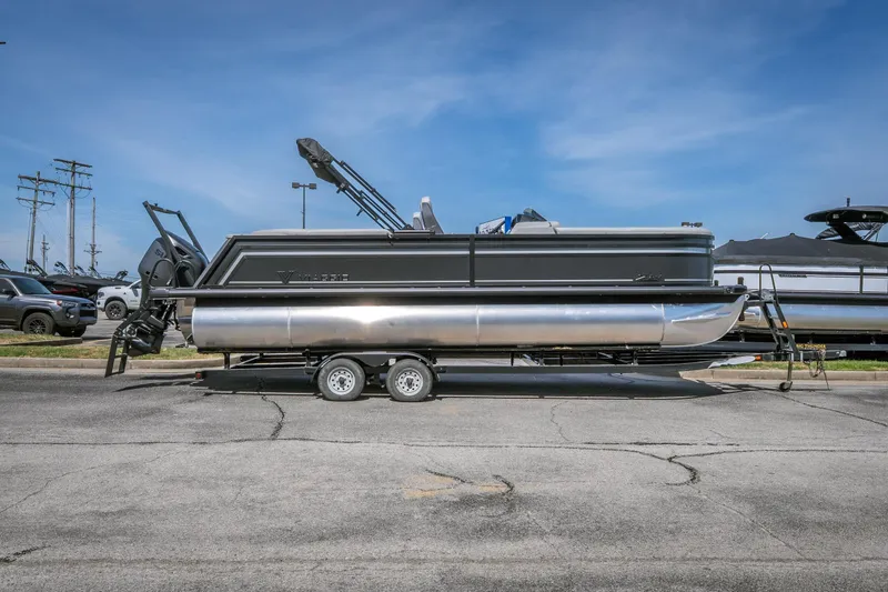 Slide: The Image of 2026 Viaggio Z24U pontoon boat on trailer, parked outdoors under clear sky. - 25