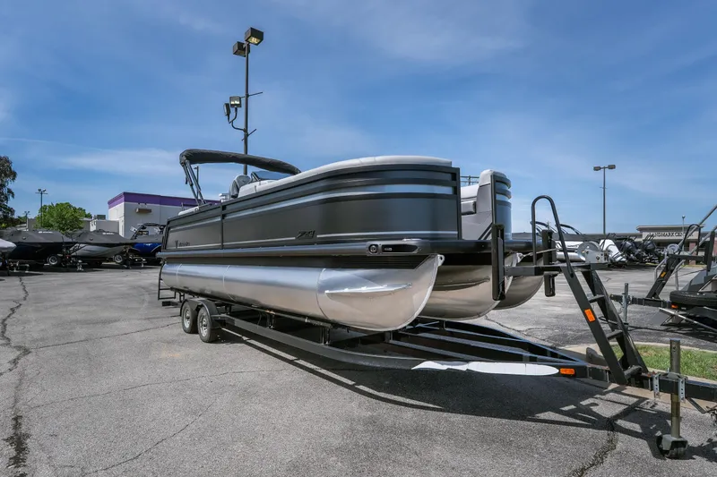 Slide: The Image of 2026 Viaggio Z24U pontoon boat on trailer in parking lot under clear blue sky. - 26
