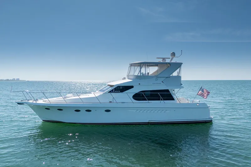 Slide: The Image of 2007 Ocean Alexander 52 Sedan yacht cruising on calm ocean waters under clear blue skies. - 4