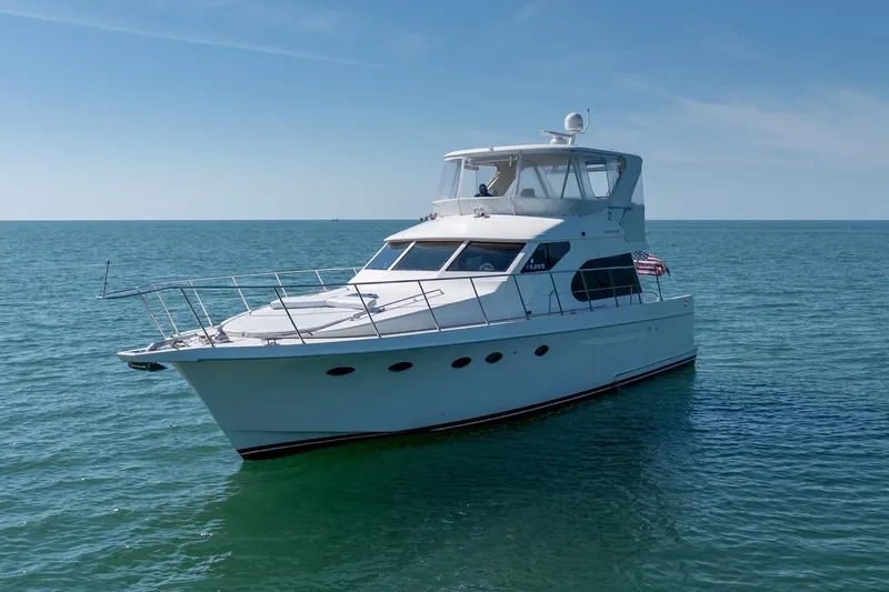 Slide: The Image of 2007 Ocean Alexander 52 Sedan yacht cruising on open sea under clear blue sky. - 5