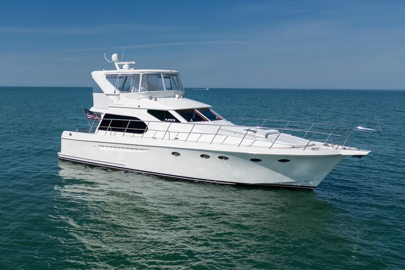 Slide: The Image of 2007 Ocean Alexander 52 Sedan yacht cruising on open sea under clear blue sky. - 7