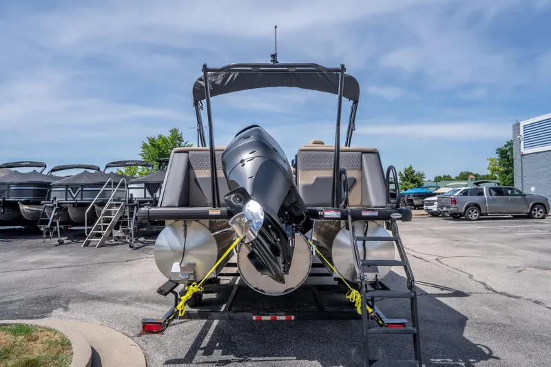 Slide: The Image of 2026 Viaggio Z24U pontoon boat with powerful outboard motor, parked outdoors. - 23