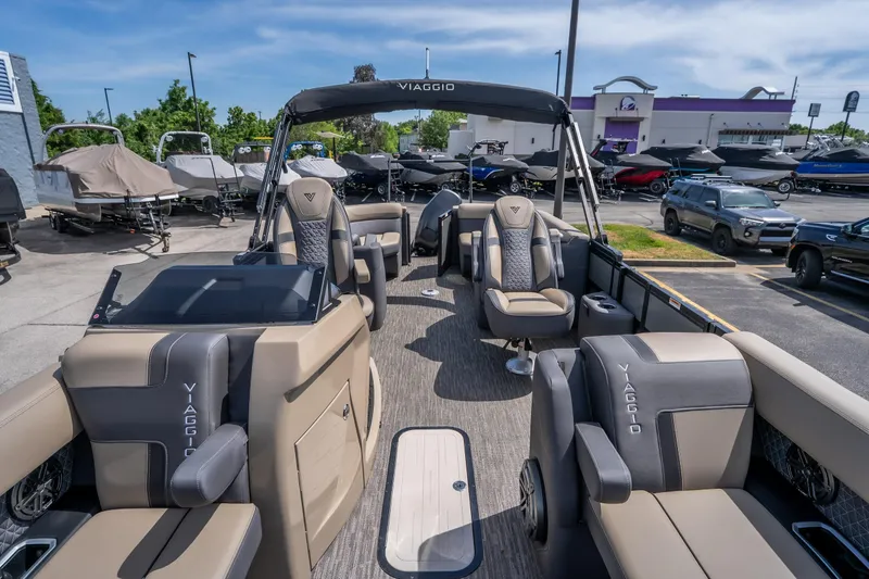 Slide: The Image of 2026 Viaggio Z24U pontoon boat with luxurious seating and modern design in a showroom. - 8
