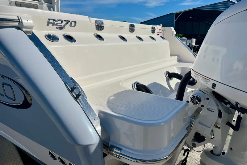 Slide: The Image of 2026 Robalo R270 Center Console boat, rear view with engine and sleek design. - 10
