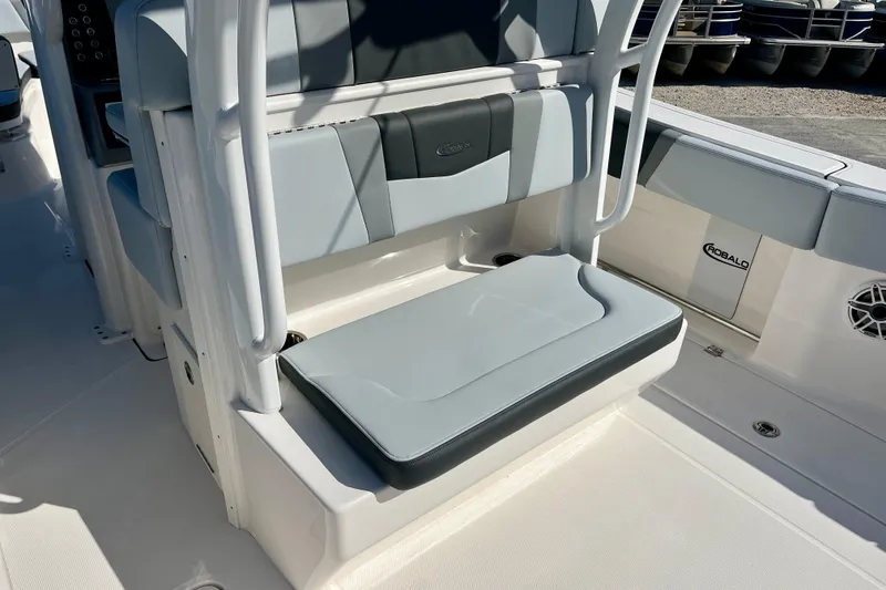Slide: The Image of 2026 Robalo R270 Center Console boat seating area with cushioned seats and sleek design. - 13