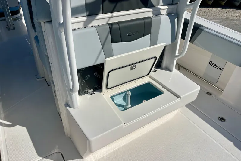 Slide: The Image of 2026 Robalo R270 Center Console boat interior with storage compartment open. - 14