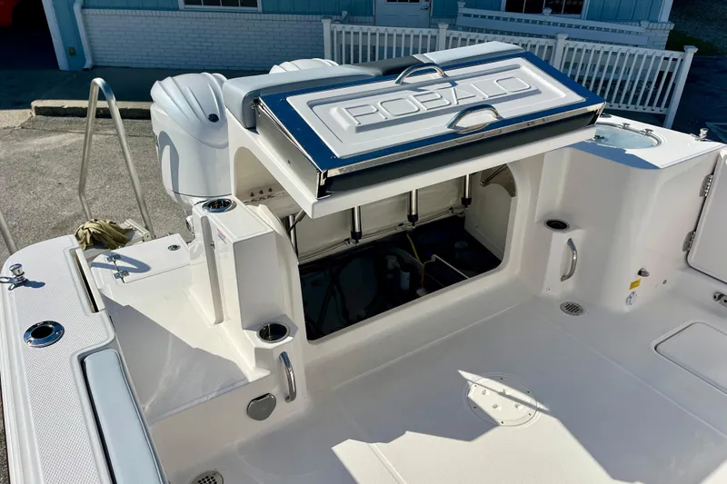 Slide: The Image of 2026 Robalo R270 Center Console boat with open storage compartment, showcasing sleek design. - 17