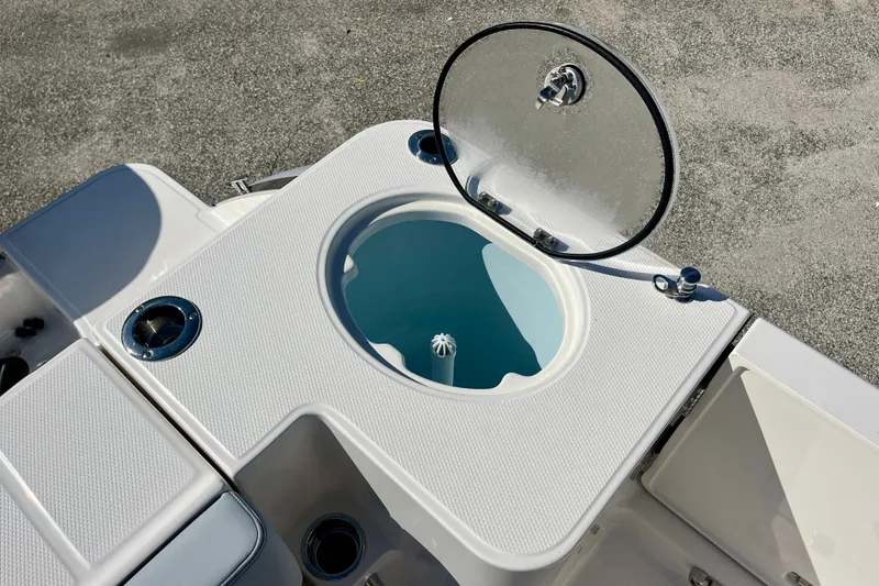 Slide: The Image of 2026 Robalo R270 Center Console boat livewell with open lid on deck. - 21