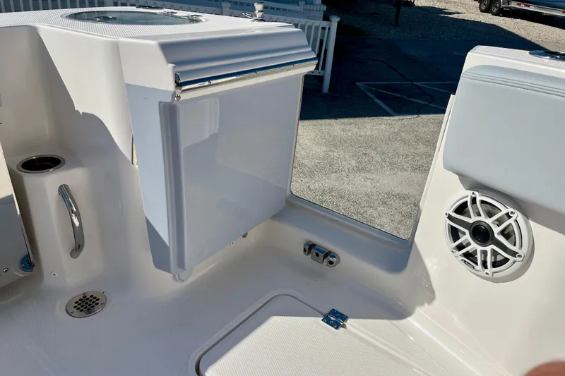 Slide: The Image of 2026 Robalo R270 Center Console boat interior with speaker and storage compartment. - 23