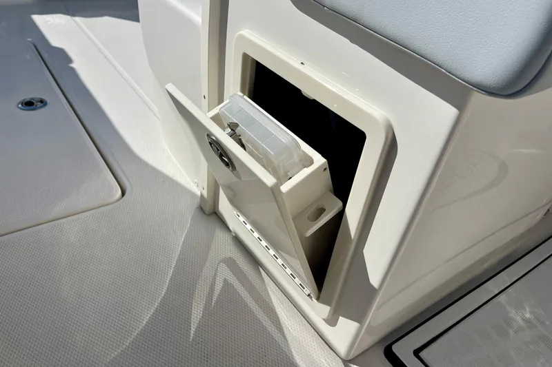 Slide: The Image of 2026 Robalo R270 Center Console storage compartment with open hatch on deck. - 27